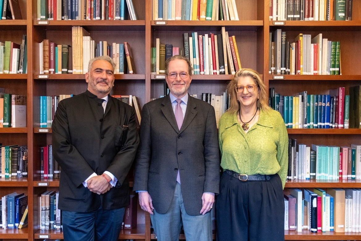 From left: M. Rahim Shayegan, Jeffrey P. Cunard and Alexandra Minna Stern smile while standing in front of floor-to-ceiling bookshelves filled with books.