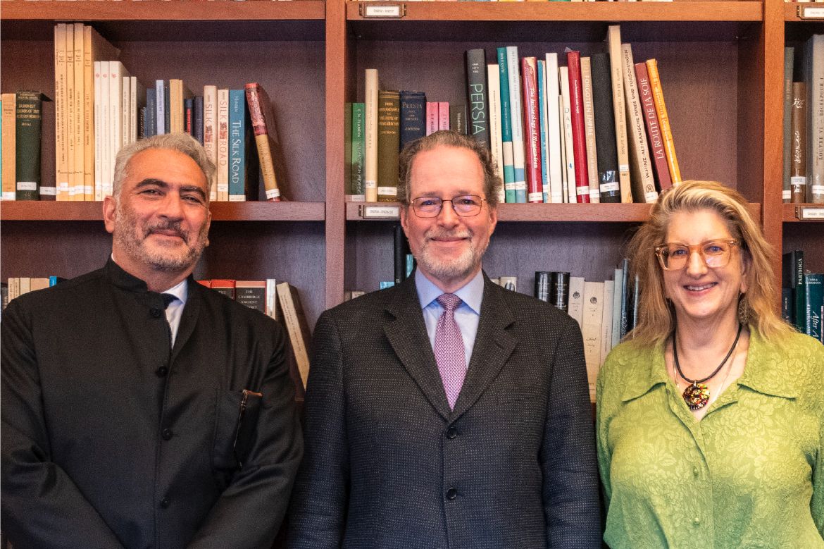 From left: M. Rahim Shayegan, Jeffrey P. Cunard and Alexandra Minna Stern smile while standing in front of floor-to-ceiling bookshelves filled with books.