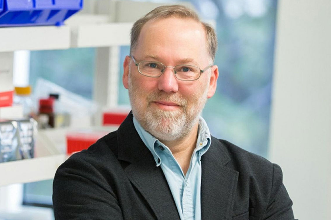 Dr. Fred Ramsdell standing in front of a lab